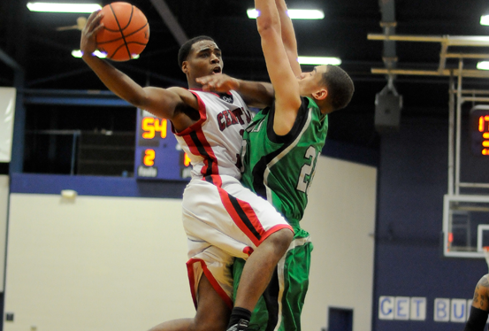 CMCC's Raymond Monroe takes it up for two against Elvis Nunez of Machias. Photo by Kim Lloyd.